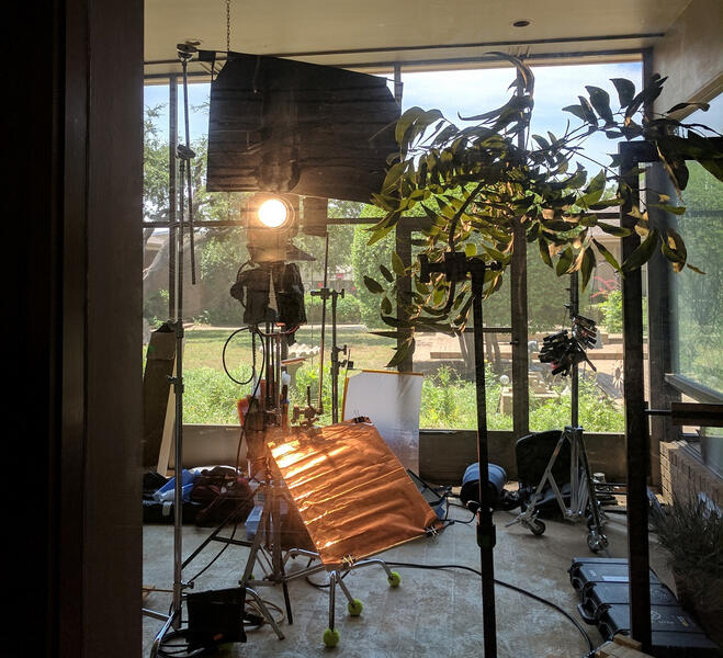 Bouncing light off a copper sheet into a branchaloris to create a realistic tree shadow.